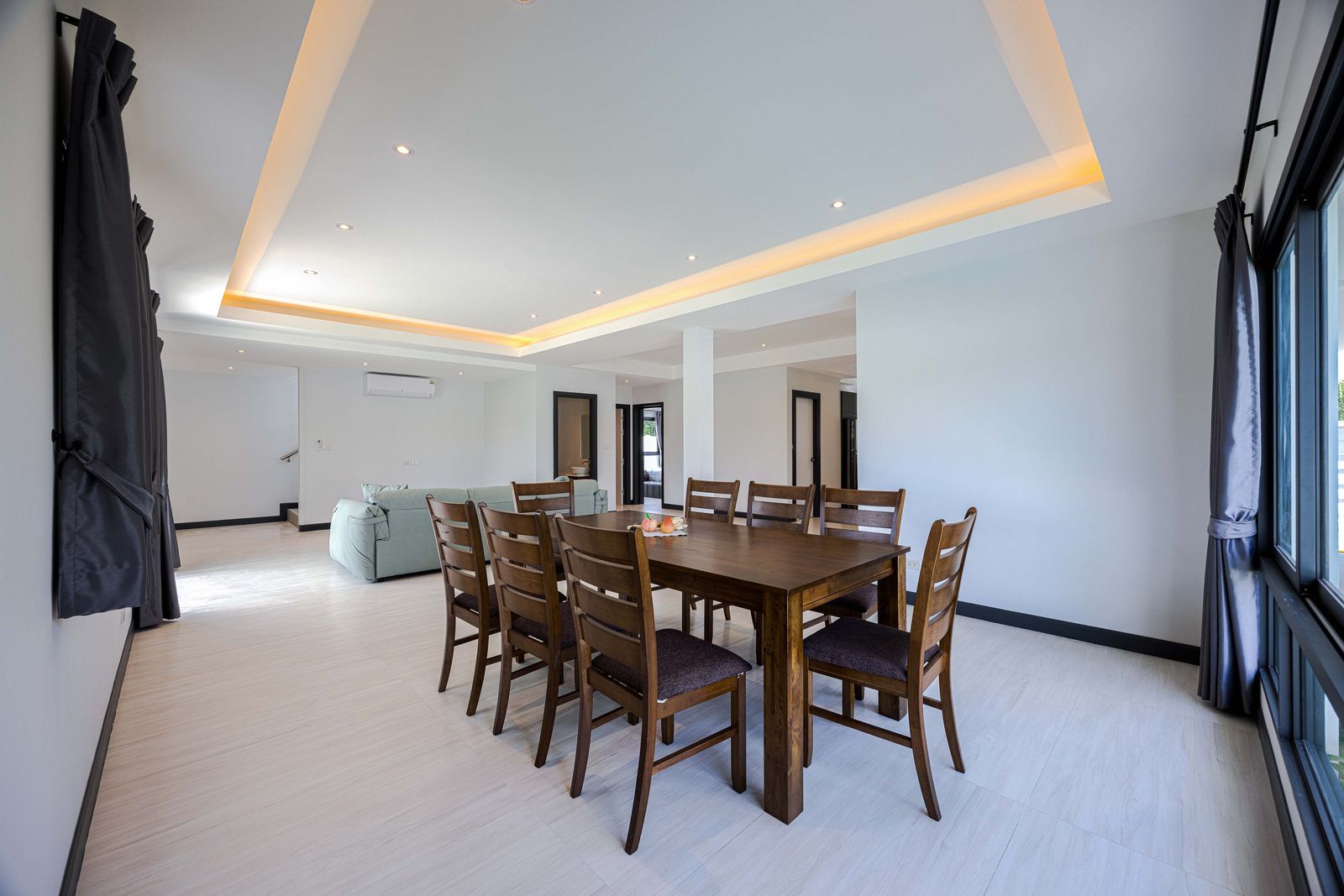 Open-plan living and dining room with a lit ceiling, Soi 102